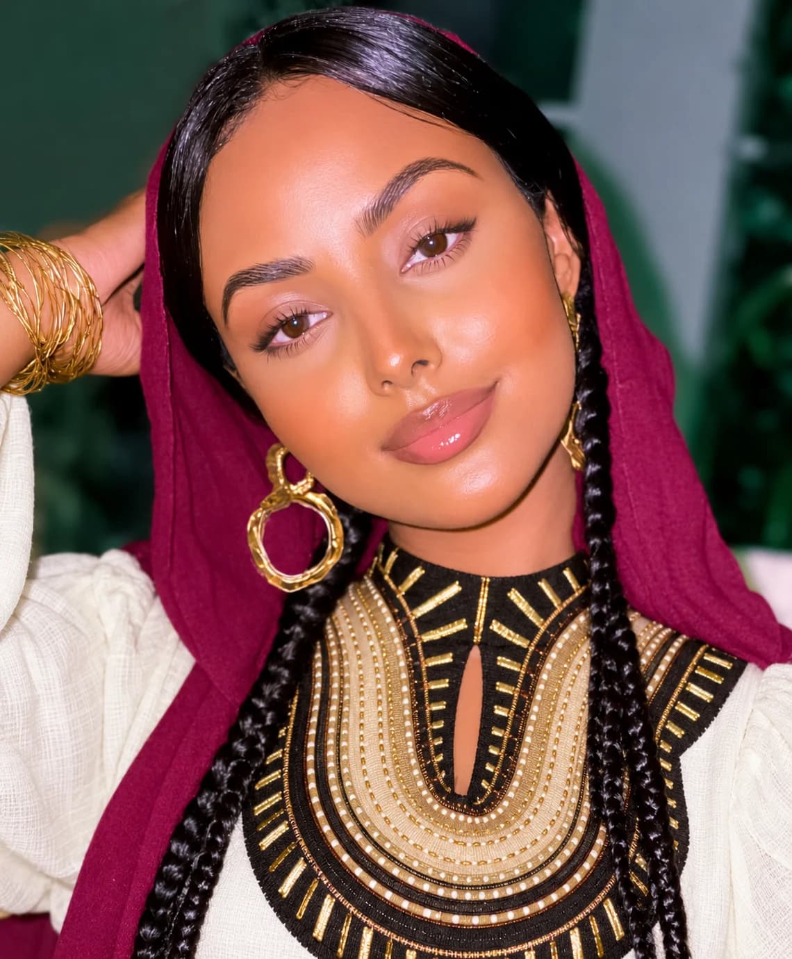 Woman wearing a traditional Habesha dress with gold jewellery